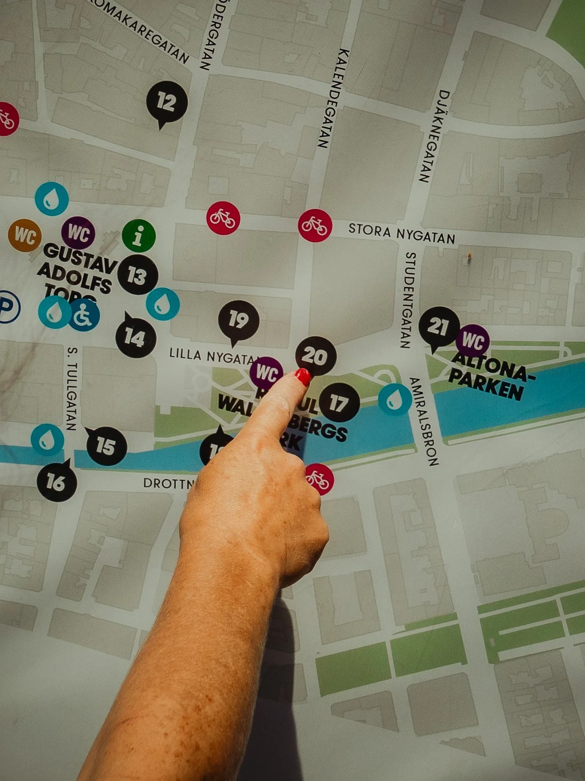 woman pointing with her finger on a map